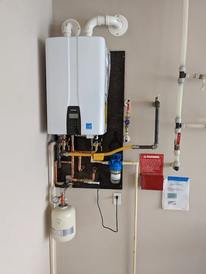 Professional plumber installing copper piping in a Braidwood home